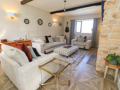 A living room with sofas and a coffee table at Yew Tree Cottage Mealsgate near Ireby