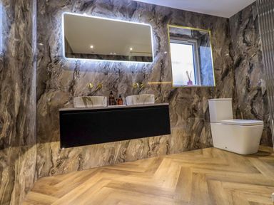 A bathroom with a double sink and toilet at Yew Tree Cottage Mealsgate near Ireby