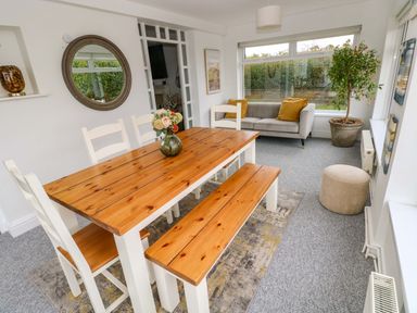 A dining room with a table and chairs at Burry House in Llanmorlais