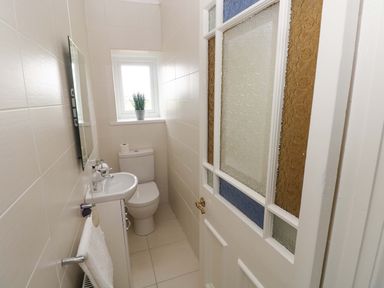 A bathroom with a toilet and sink at Burry House in Llanmorlais