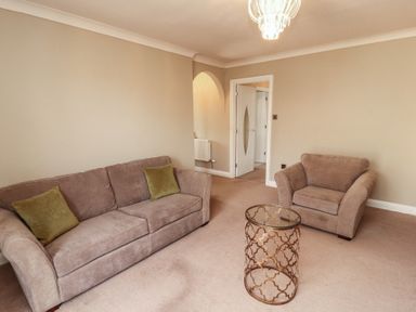 A living room with a sofa and coffee table at 3 Hawk Place Moresby Parks near Whitehaven
