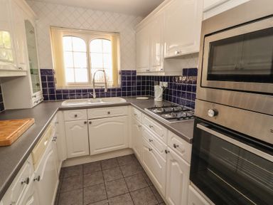 A kitchen with cabinets and appliances at 3 Hawk Place in Moresby Parks near Whitehaven