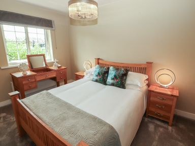 A bedroom with a bed and furniture at 3 Hawk Place Moresby Parks near Whitehaven