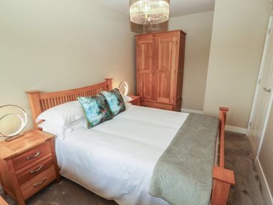 A bedroom with a bed and wardrobe at 3 Hawk Place in Moresby Parks near Whitehaven