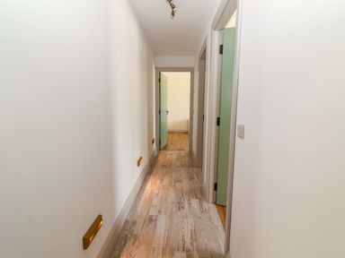 A hallway with doors and a light fixture at Teach Ti in Miltown Malbay