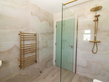 A bathroom with a shower and towel rail at Teach Ti in Miltown Malbay