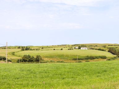 A house surrounded by grassy fields at Teach Ti in Miltown Malbay