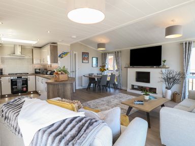 A living room with a kitchen and dining area at Life's a Beach in Bacton