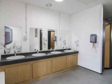 A public restroom with three sinks and mirrors above a wooden cabinet at Buttercup (Cow Shed 3) in Easton near Campsea Ashe