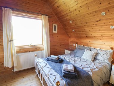 A bedroom with a bed and window at Pen Y Clawdd near Beggar's Bush near Presteigne