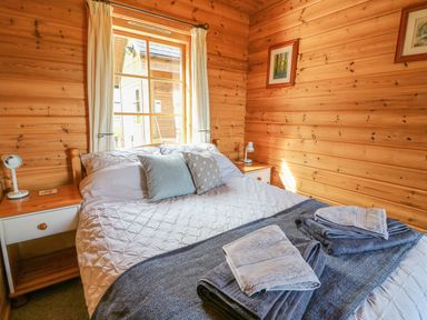 A bedroom with a bed and window at Dan Y Coed near Presteigne