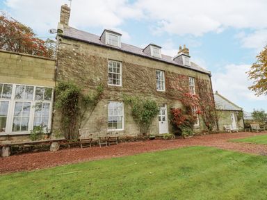 A building with windows and garden at Elford Farmhouse Seahouses