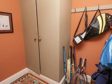 A storage room with tennis rackets and sport bags at Elford Farmhouse in Seahouses