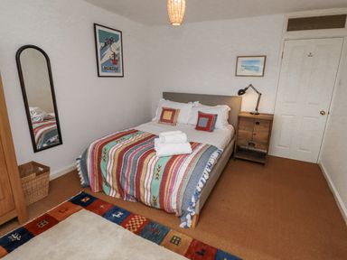 A bedroom with a bed and bedside table at Elford Farmhouse in Seahouses