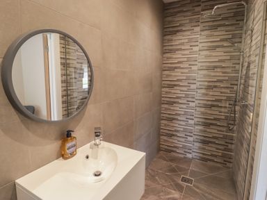 A bathroom with a sink and shower installed at The Lodge in Bridgend
