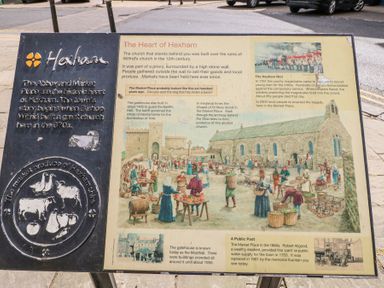 An informational sign about the history of Hexham and its market place with illustrations of historical scenes at The Barn in Riding Mill near Corbridge