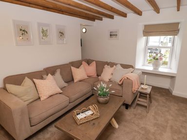 A living room with a sofa and coffee table at Penwyn in Solva