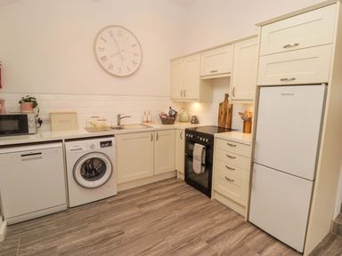 A kitchen with appliances and cabinets at Penwyn in Solva