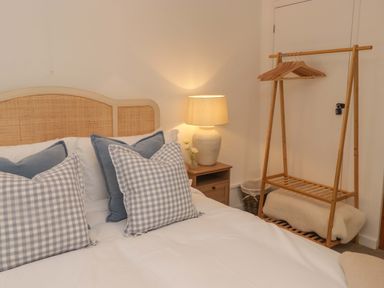 A bedroom with a bed and lamp at Penwyn in Solva