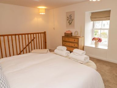 A bedroom with a bed and towels on it at Penwyn in Solva