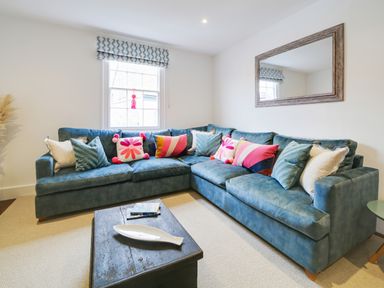 A living room with a couch and coffee table at Church Hill House Port Isaac