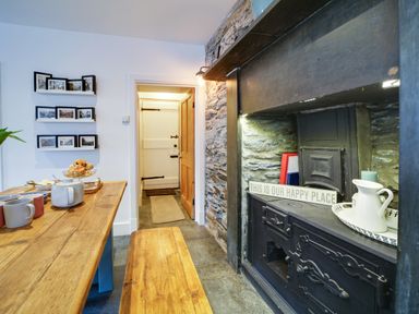 A kitchen with a table and mugs at Church Hill House in Port Isaac