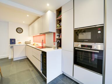 A kitchen with modern appliances and storage at Church Hill House in Port Isaac