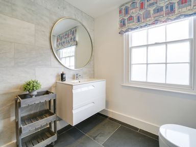 A bathroom with a mirror and sink at Church Hill House in Port Isaac