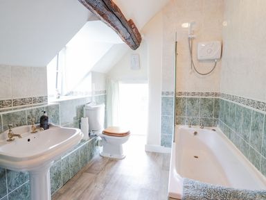 A bathroom with a sink a toilet a bathtub and a shower at Ty Glan Yr Afon Bontddu near Dolgellau
