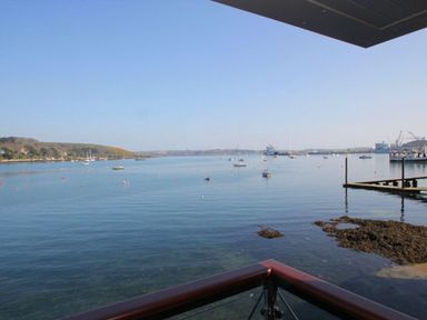 A view of a harbor with boats on water seen from a balcony at Tobys Quay in Falmouth