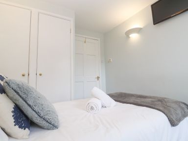 A bedroom with a bed and closet at Tobys Quay in Falmouth