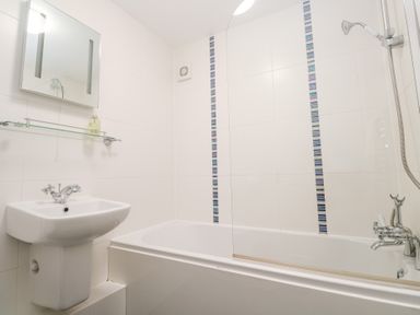 A bathroom with a bathtub and sink at Tobys Quay Falmouth