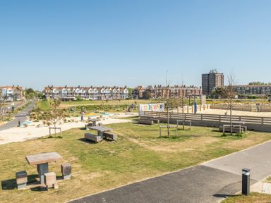 An outdoor park with seating and nearby buildings at Marine Court First-floor Double Bedroom with Bathroom Littlehampton