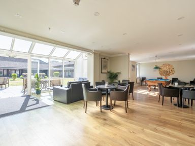 A common area with chairs and tables at Marine Court First-floor Double Bedroom with Bathroom in Littlehampton