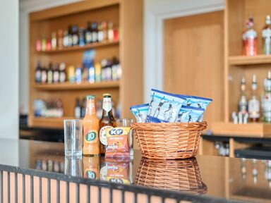 A bar counter with drinks and snacks at Marine Court First-floor Double Bedroom with Bathroom Littlehampton
