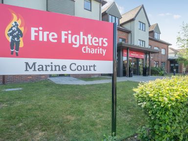 A sign for Fire Fighters Charity at Marine Court Littlehampton