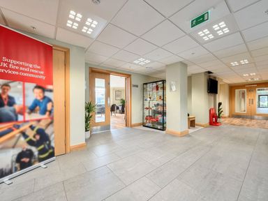 A lobby with a glass display cabinet and doors at Marine Court First-floor Double Bedroom with Bathroom Littlehampton