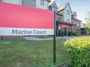 A sign for Marine Court in front of a building at Marine Court First-floor Double Bedroom with Bathroom Littlehampton
