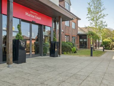 An entrance with a sign at Marine Court in Littlehampton