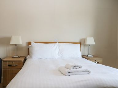 A bedroom with a bed and lamps at Bedroom 9 in Littlehampton