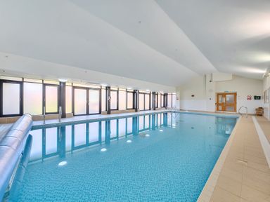An indoor swimming pool with a shallow area at Marine Court First Floor Double with Shower Room in Littlehampton