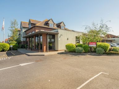 A building entrance with parking and signage at Marine Court First Floor Double with Shower Room Littlehampton