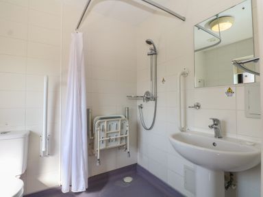A bathroom with a shower, sink, and toilet at Sunset Quarters at Marine Court in Littlehampton