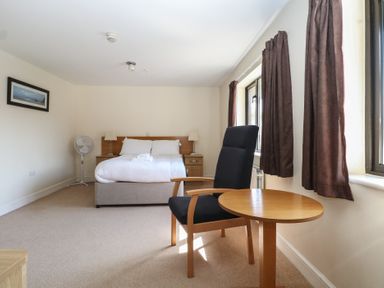 A bedroom with a bed and furniture at Sunset Quarters at Marine Court Littlehampton
