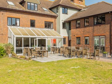 A garden area with tables and chairs at Marine Court First-floor Double Bedroom with Wet Room Littlehampton