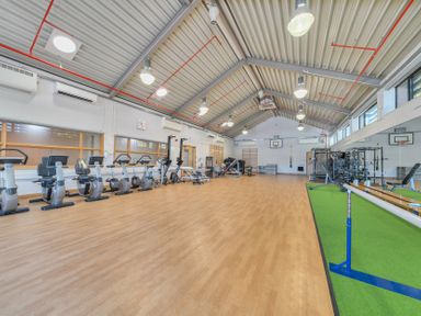 A gym with exercise equipment and flooring at Marine Court First-floor Double Bedroom with Wet Room Littlehampton