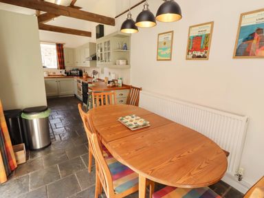 A dining area with table and chairs in a kitchen at 3 Christon Bank Mews Christon Bank