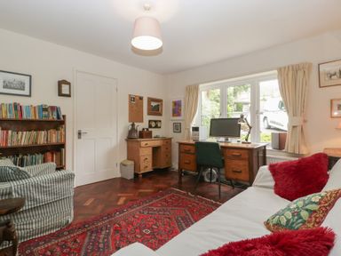 A living room with a desk and computer at St. Marys House Church Westcote near Bledington