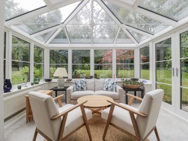 A conservatory with seating and plants at St. Marys House, Church Westcote near Bledington