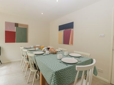 A dining room with a table set for meals at St. Marys House in Church Westcote near Bledington